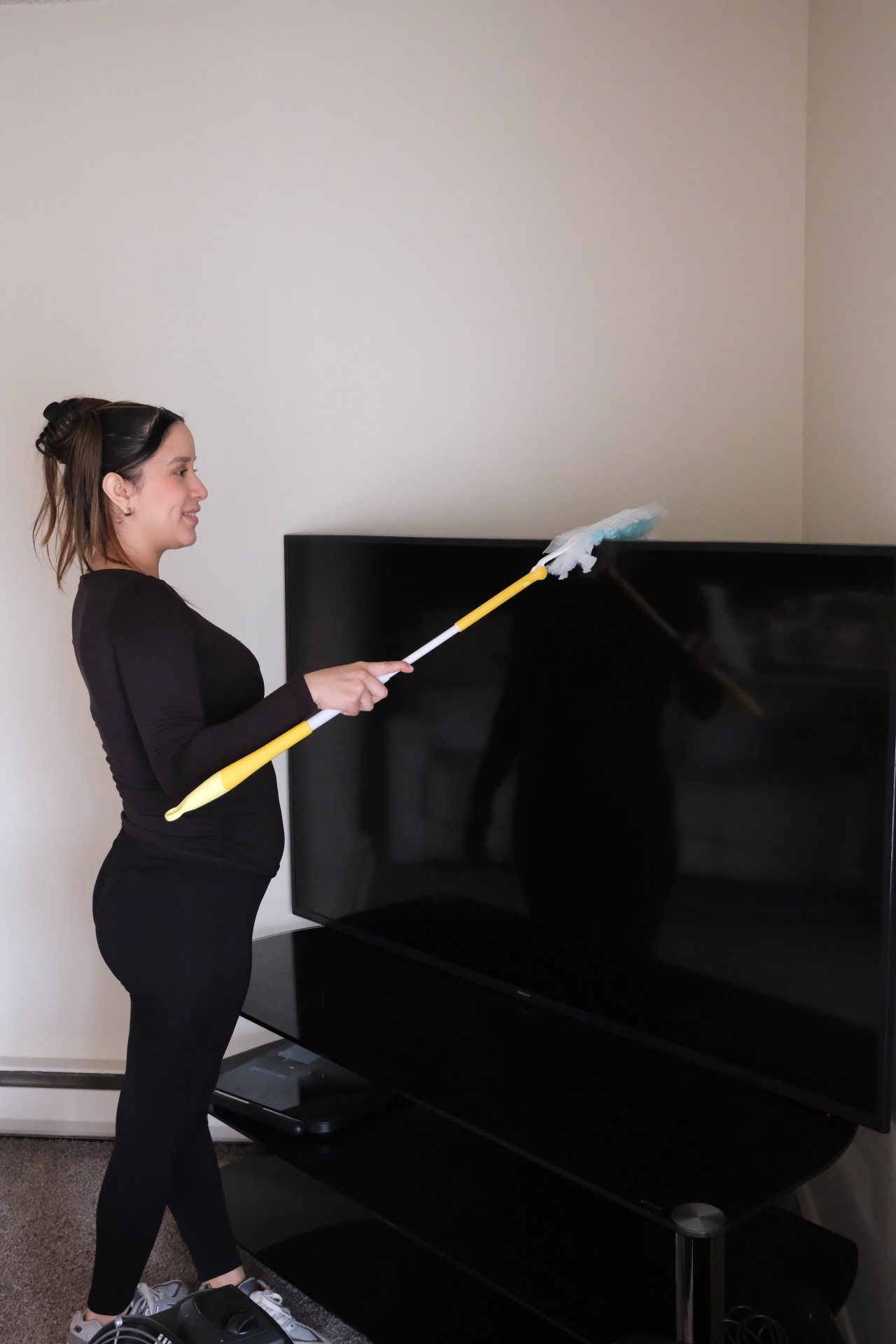 Dusting a TV with a duster