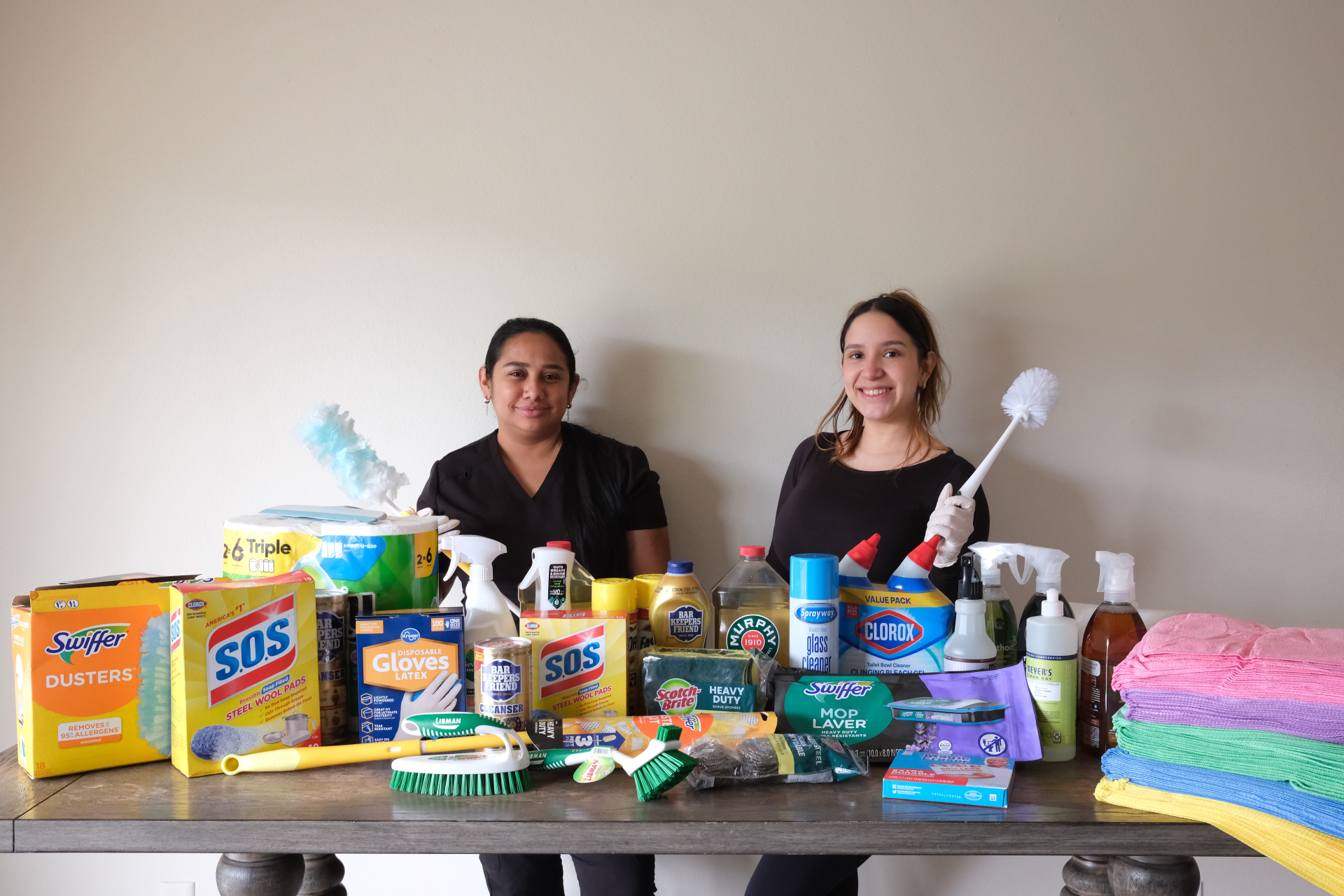 Linda and Danileth, co-founders of Sparkle & Shine, with their cleaning supplies